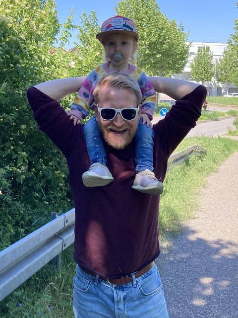 Bernhard Weyrauch carrying his daughter on his shoulders