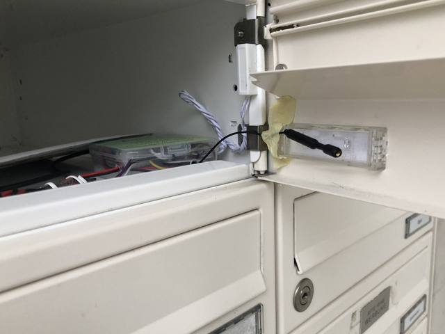 The mailbox sensor installed inside the mailbox, antenna poking out next to the flap